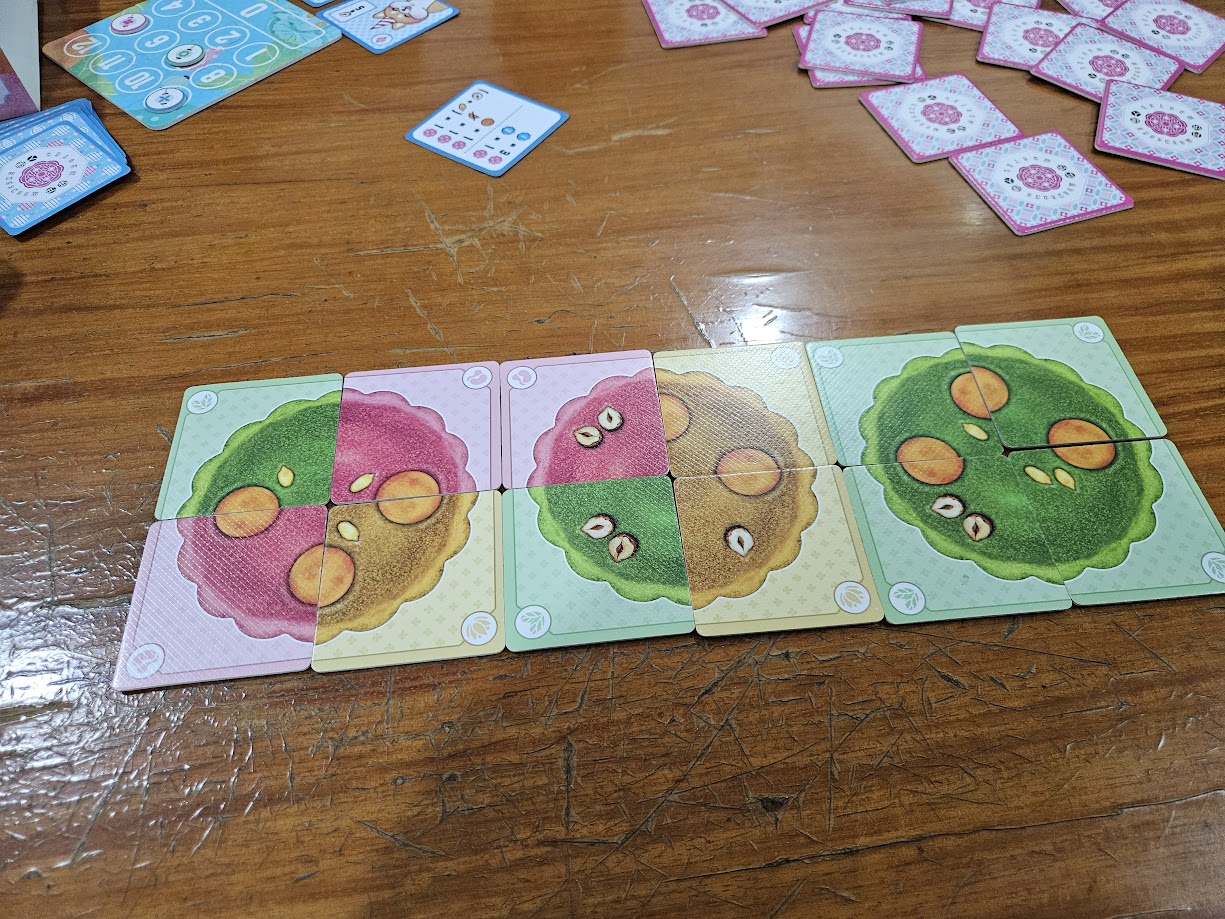 Gameplay photo of the board game Mooncake Master featuring various components and board state.