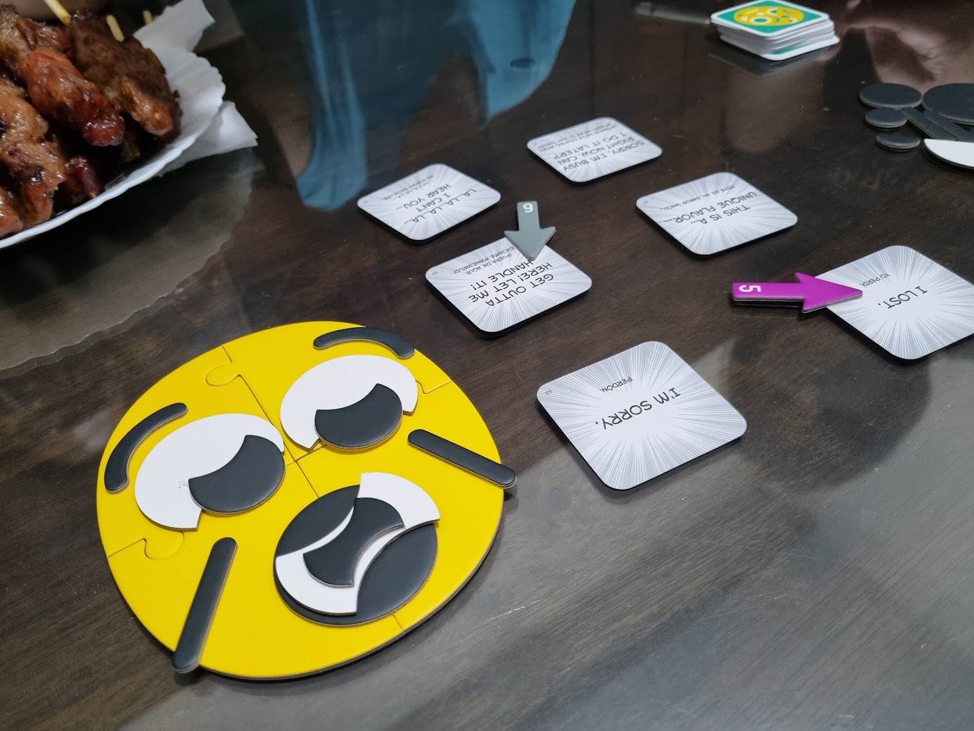 Gameplay photo of the board game Mr. Face featuring various components and board state.