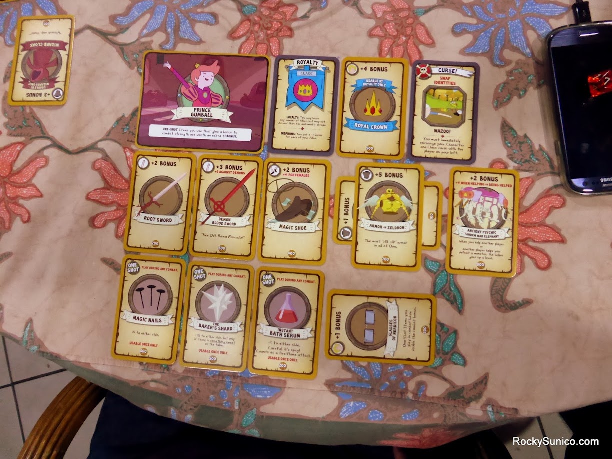 Gameplay photo of the board game Munchkin Adventure Time featuring various components and board state.