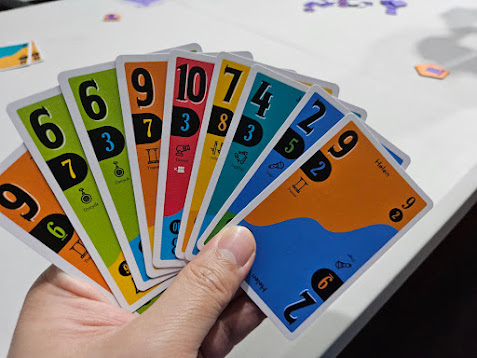 Gameplay photo of the board game SCOUT featuring various components and board state.