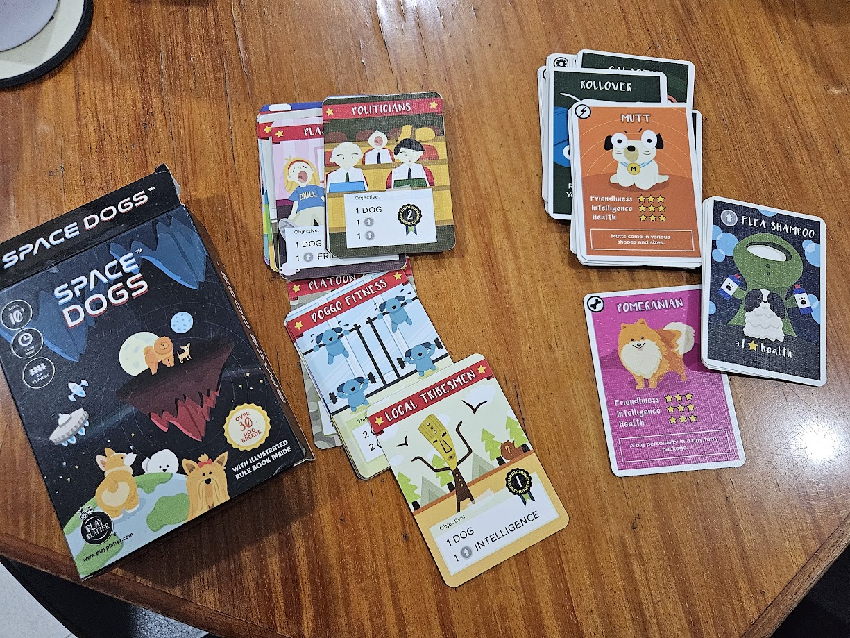 Gameplay photo of the board game Space Dogs featuring various components and board state.