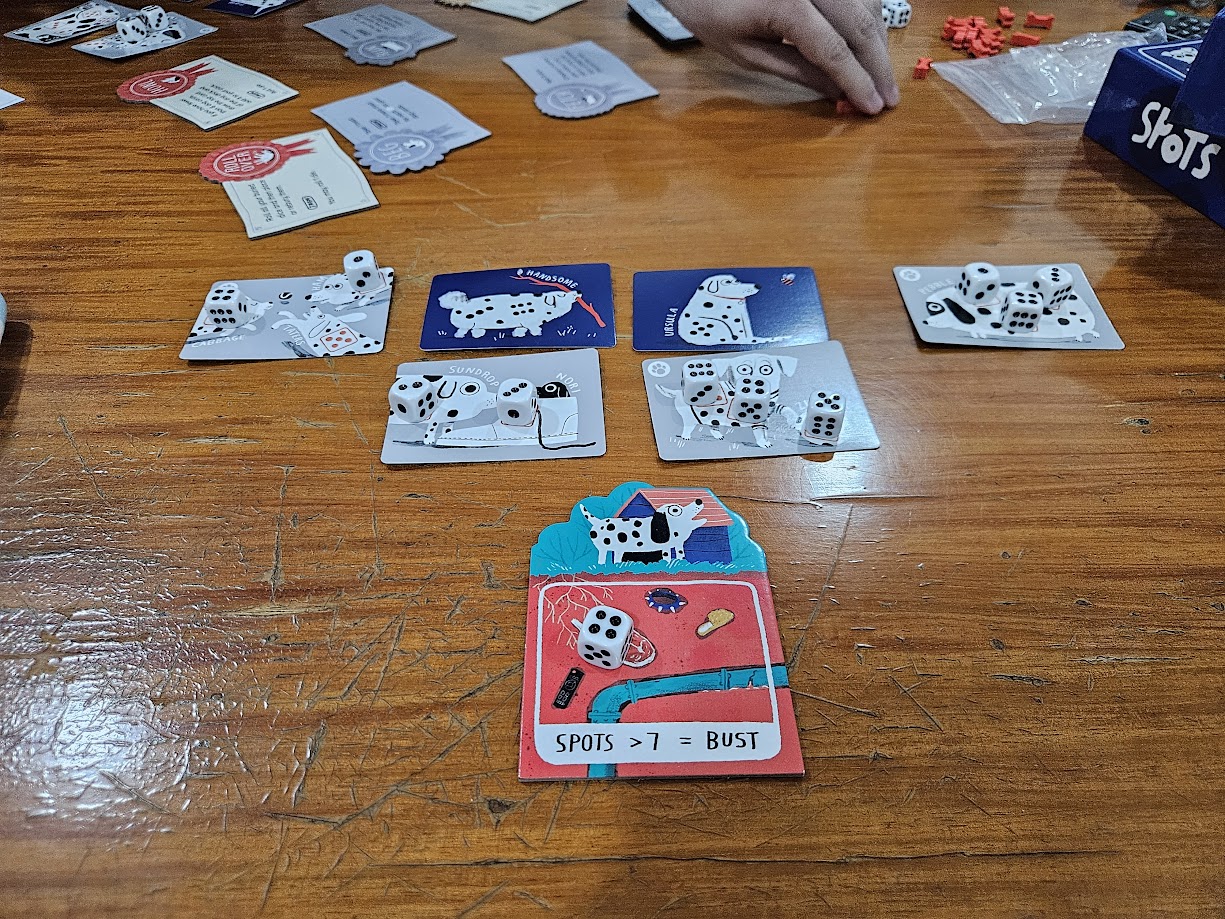 Gameplay photo of the board game Spots featuring various components and board state.