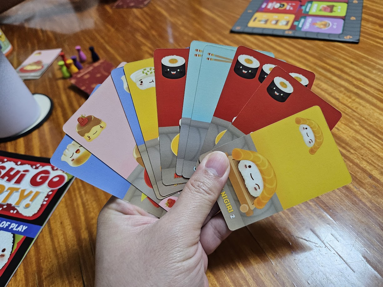 Gameplay photo of the board game Sushi Go Party! featuring various components and board state.