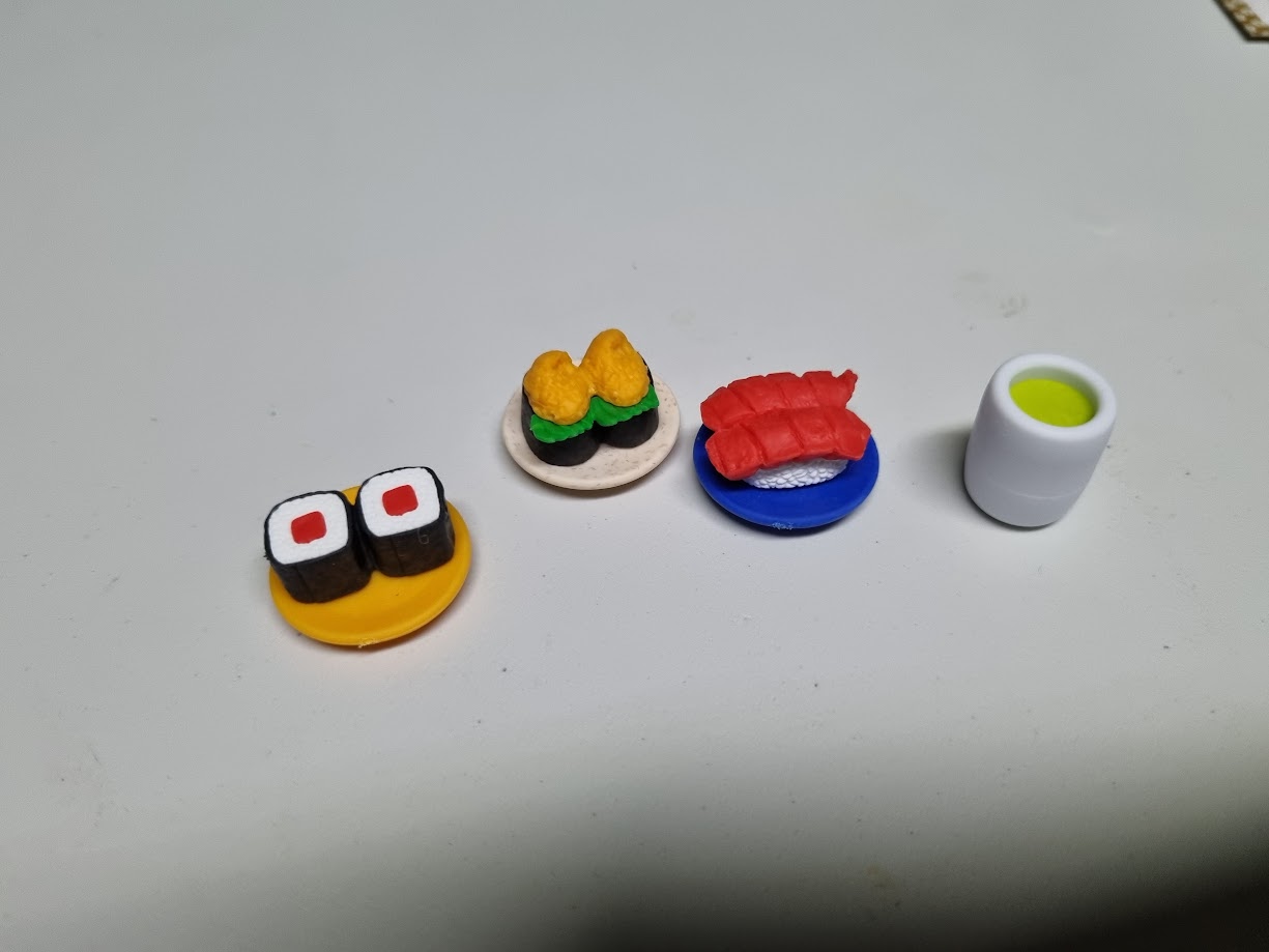 Gameplay photo of the board game Sushi Royale featuring various components and board state.