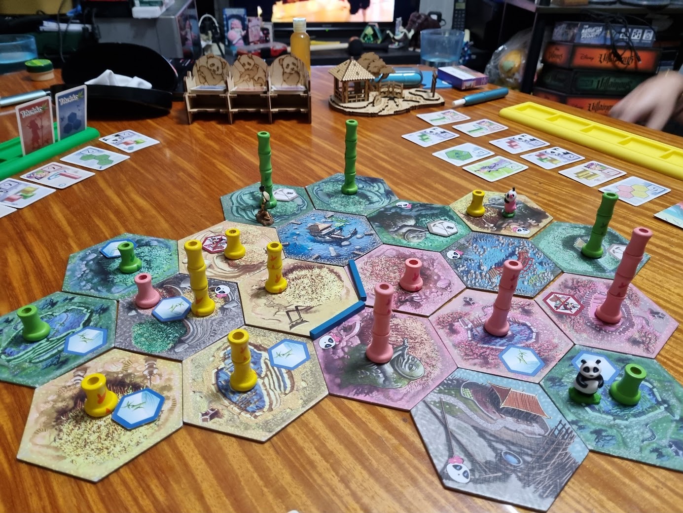 Gameplay photo of the board game Takenoko: Chibis featuring various components and board state.