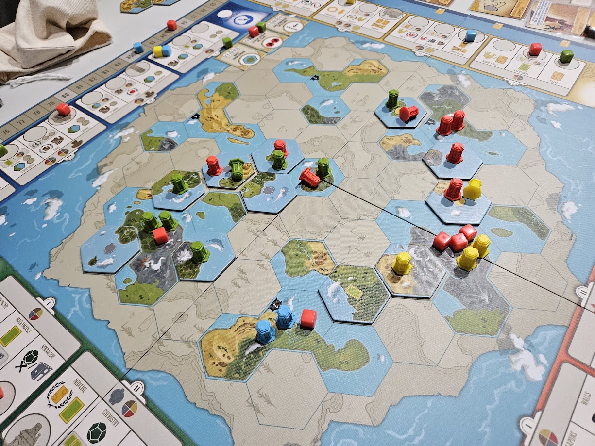 Gameplay photo of the board game Tapestry featuring various components and board state.