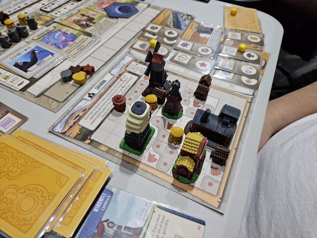 Gameplay photo of the board game Tapestry: Plans and Ploys featuring various components and board state.