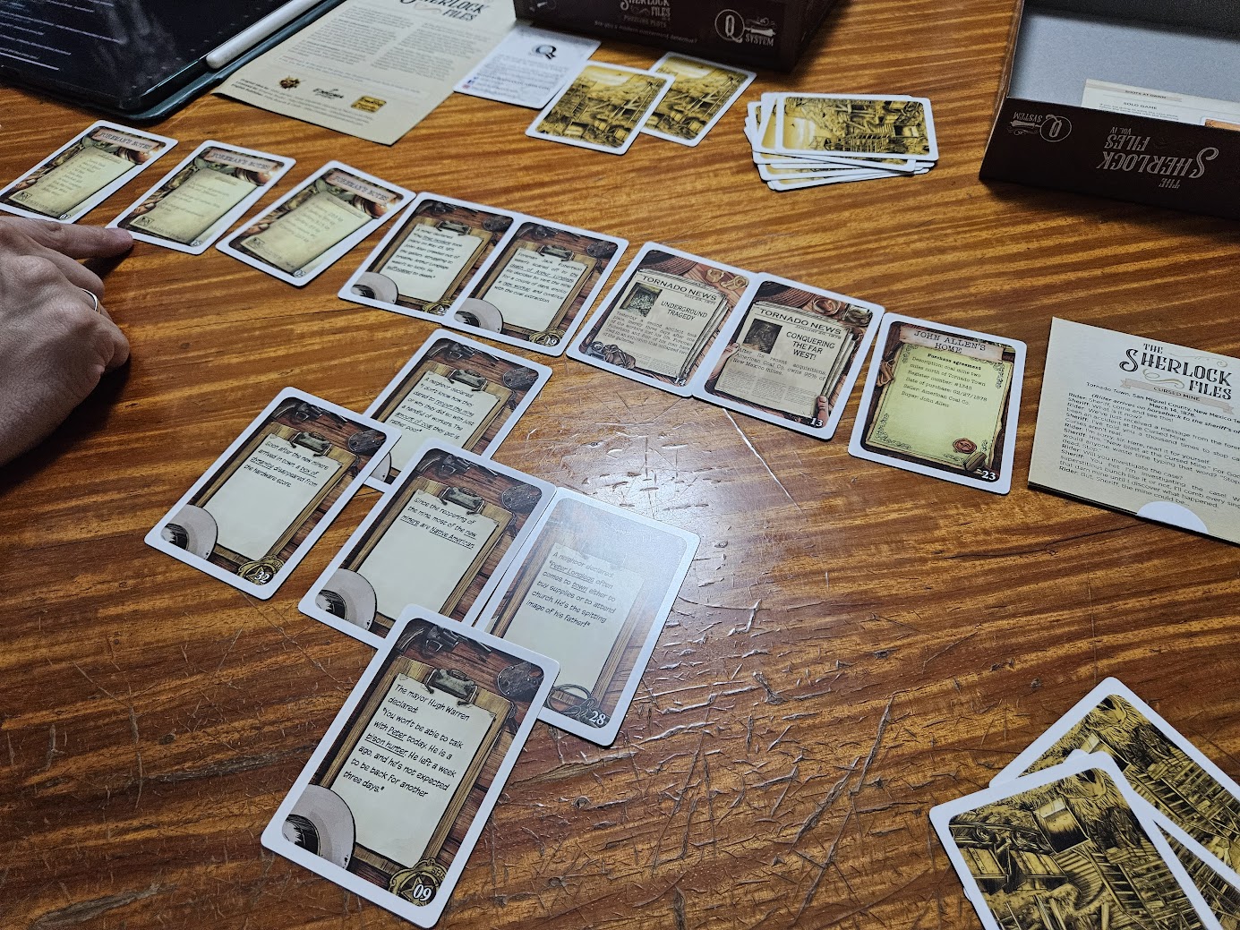 Gameplay photo of the board game The Sherlock Files: Vol IV – Fatal Frontiers featuring various components and board state.