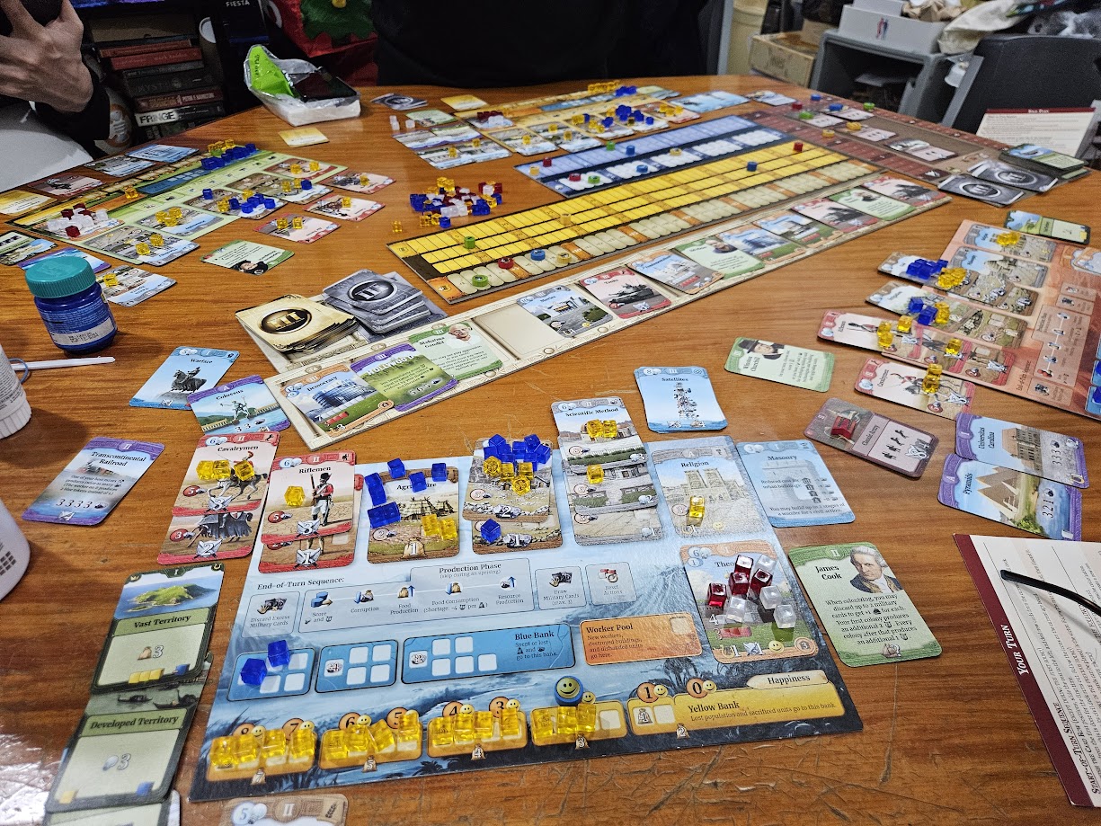 Gameplay photo of the board game Through the Ages: A New Story of Civilization featuring various components and board state.