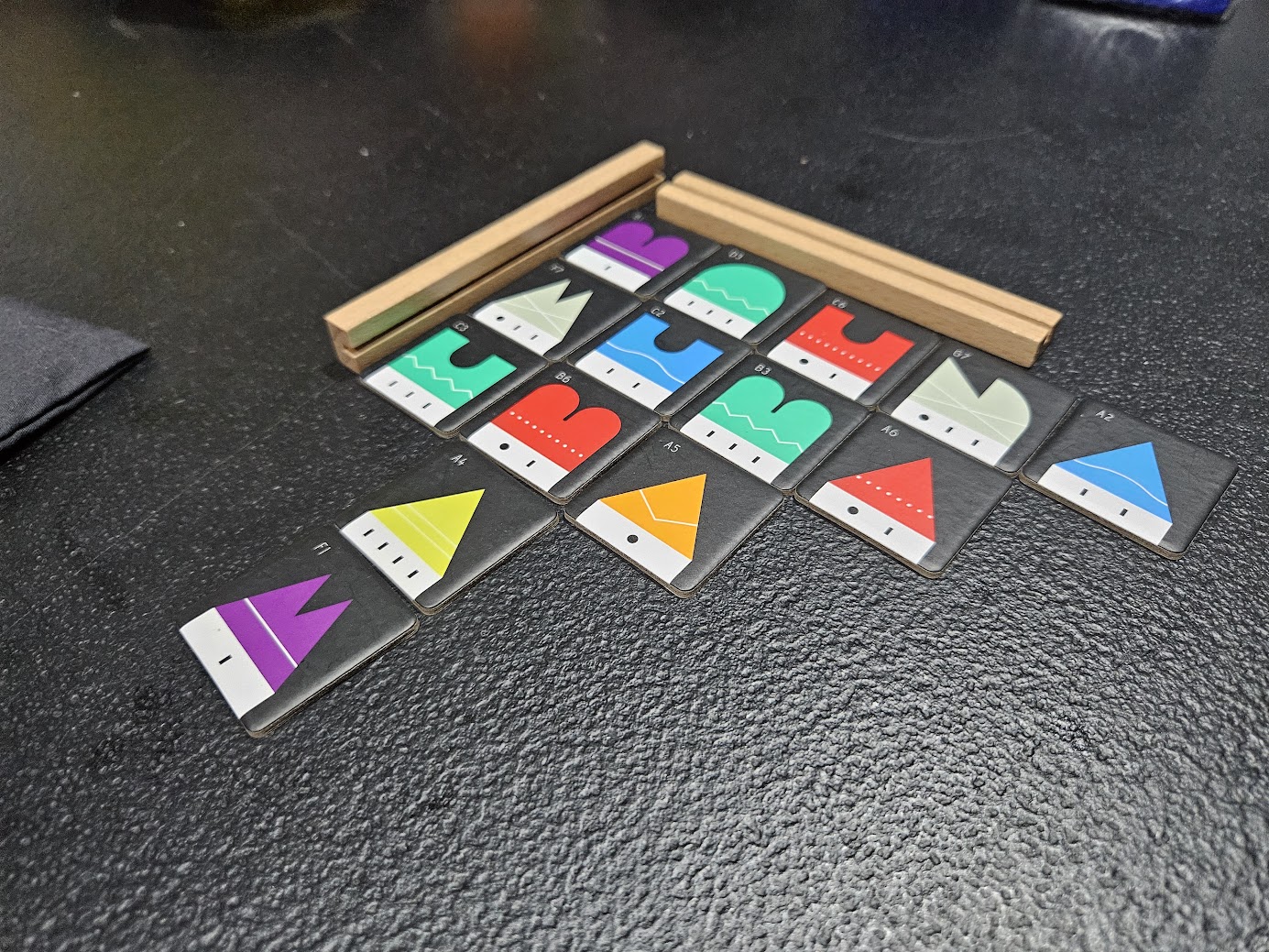 Gameplay photo of the board game Town 77 featuring various components and board state.