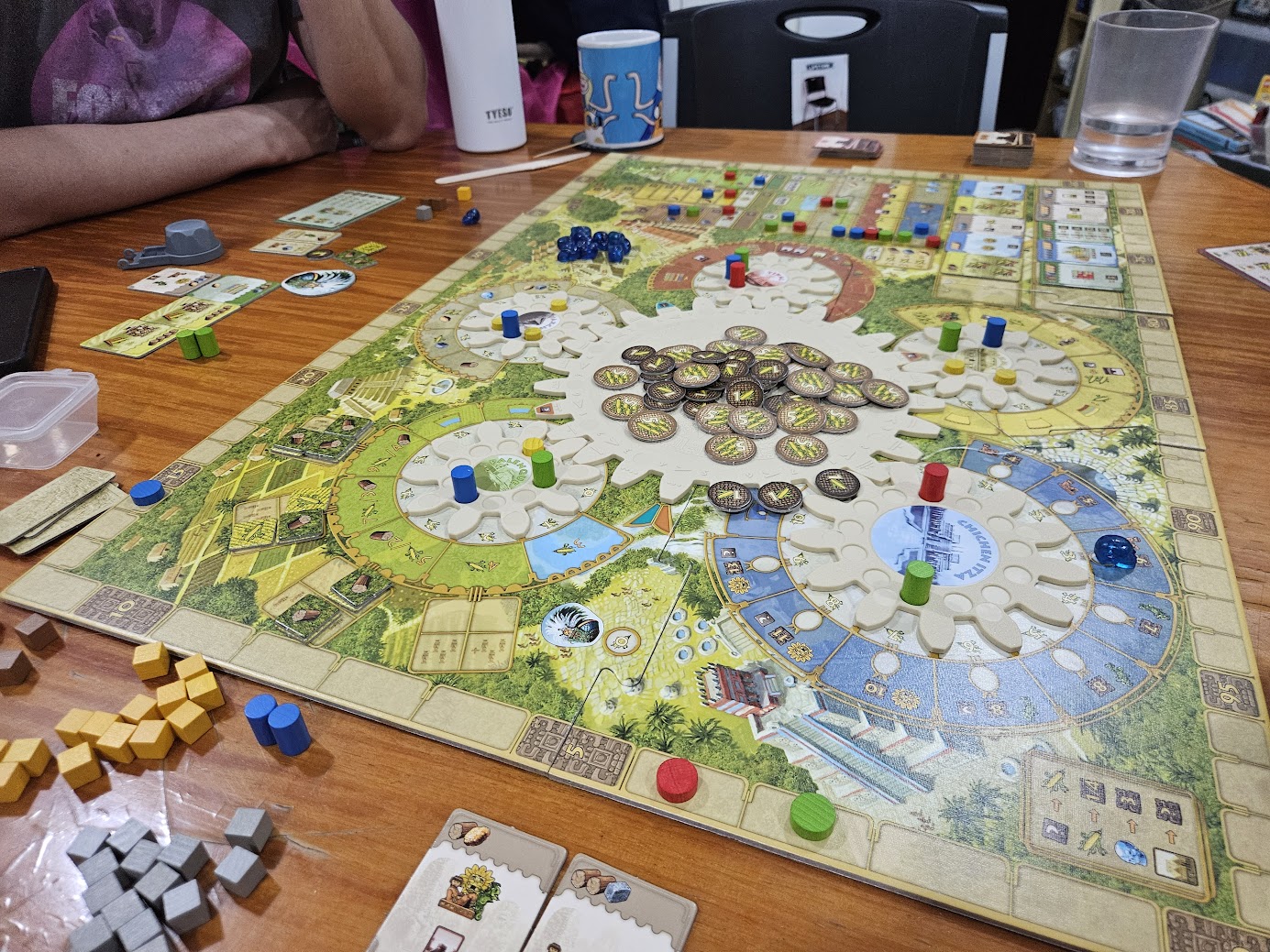 Gameplay photo of the board game Tzolk'in: The Mayan Calendar featuring various components and board state.