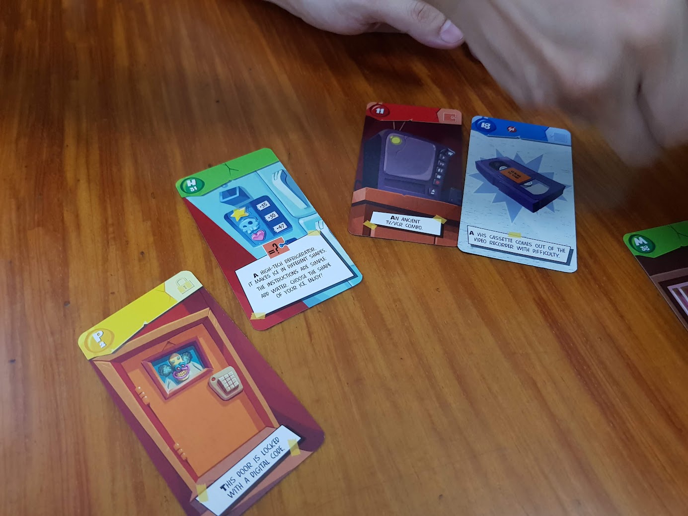 Gameplay photo of the board game Unlock!: Escape Adventures – Squeek & Sausage featuring various components and board state.