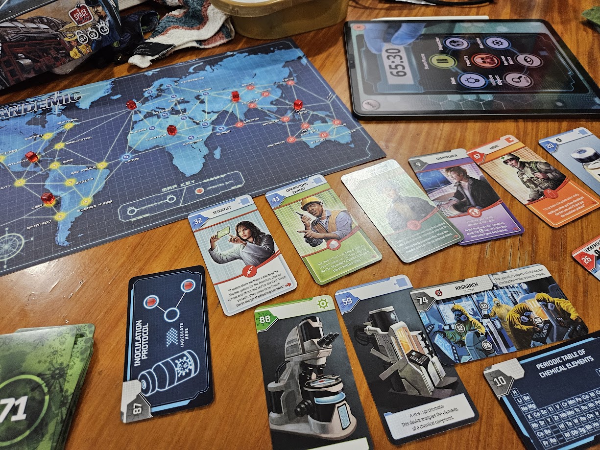Gameplay photo of the board game Unlock!: Game Adventures featuring various components and board state.