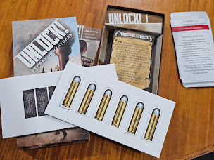 Gameplay photo of the board game Unlock!: Secret Adventures – Tombstone Express featuring various components and board state.