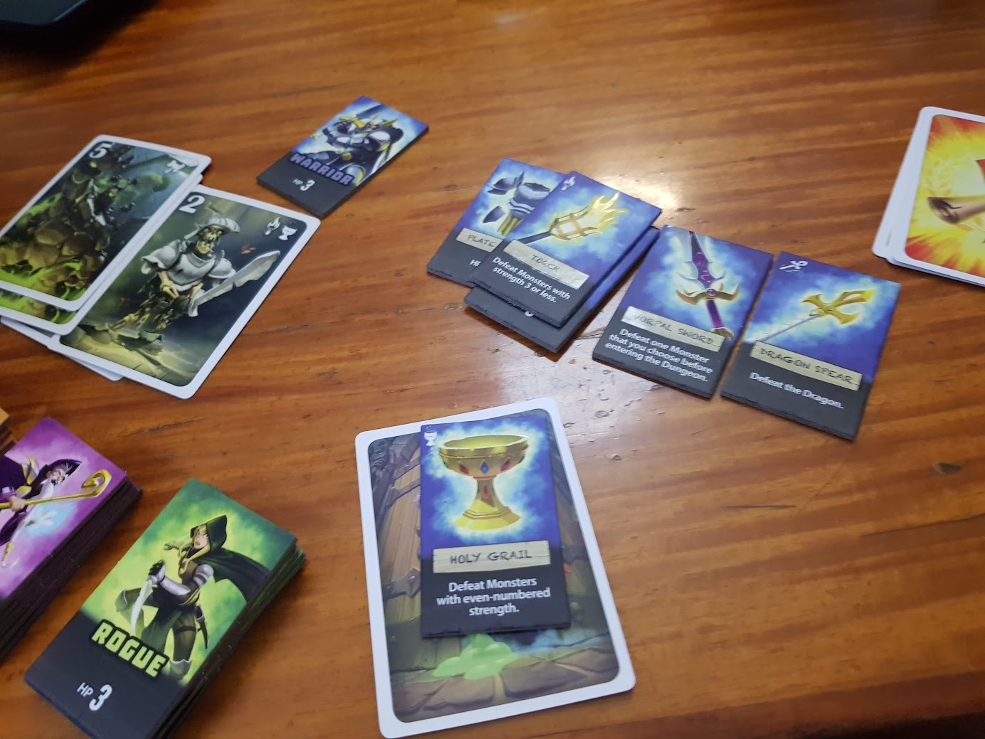Gameplay photo of the board game Welcome to the Dungeon featuring various components and board state.
