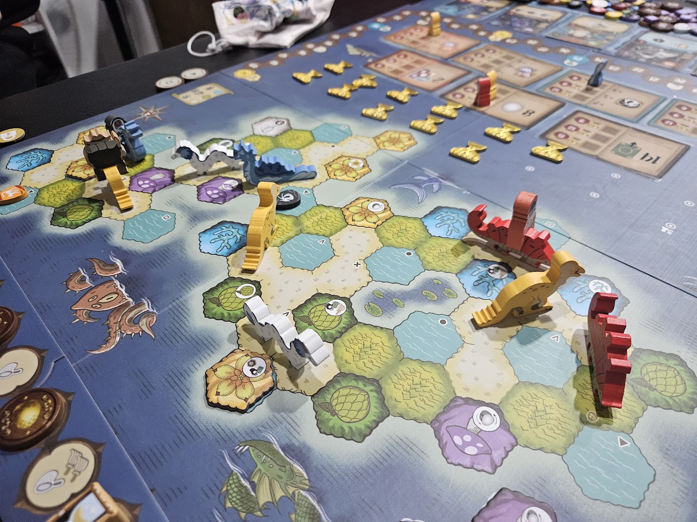 Gameplay photo of the board game Wondrous Creatures featuring various components and board state.