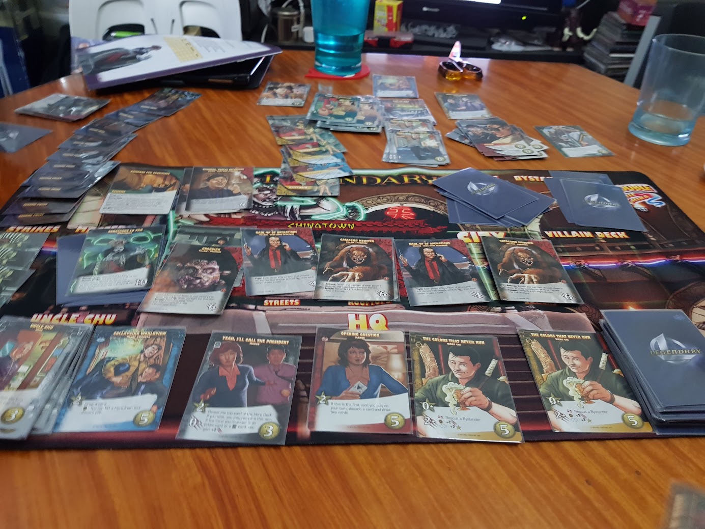 Gameplay photo of the board game Legendary: Big Trouble in Little China featuring various components and board state.
