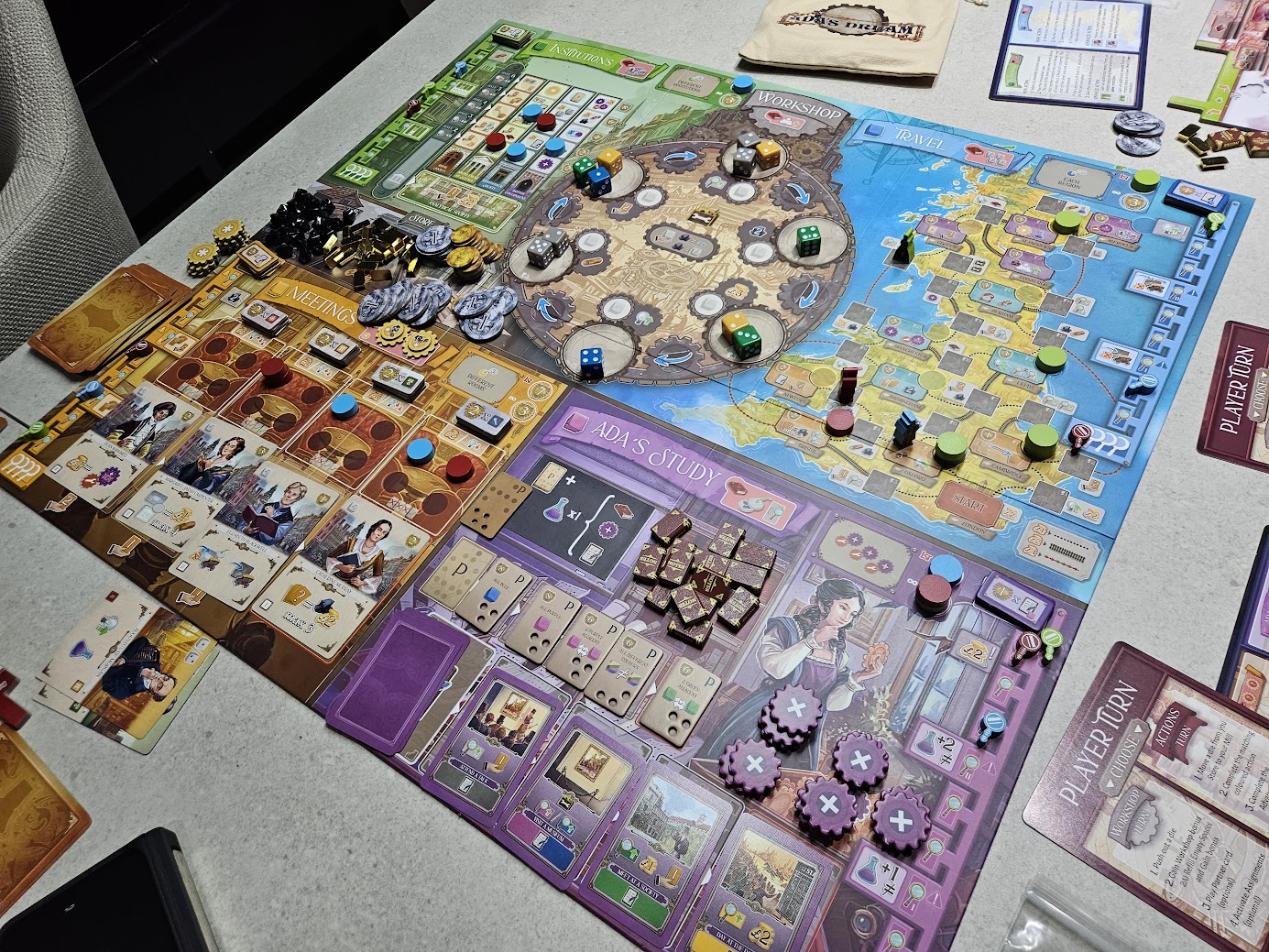 Gameplay photo of the board game Ada's Dream featuring various components and board state.
