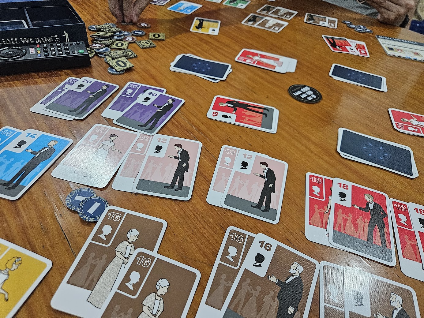 Gameplay photo of the board game Shall We Dance featuring various components and board state.