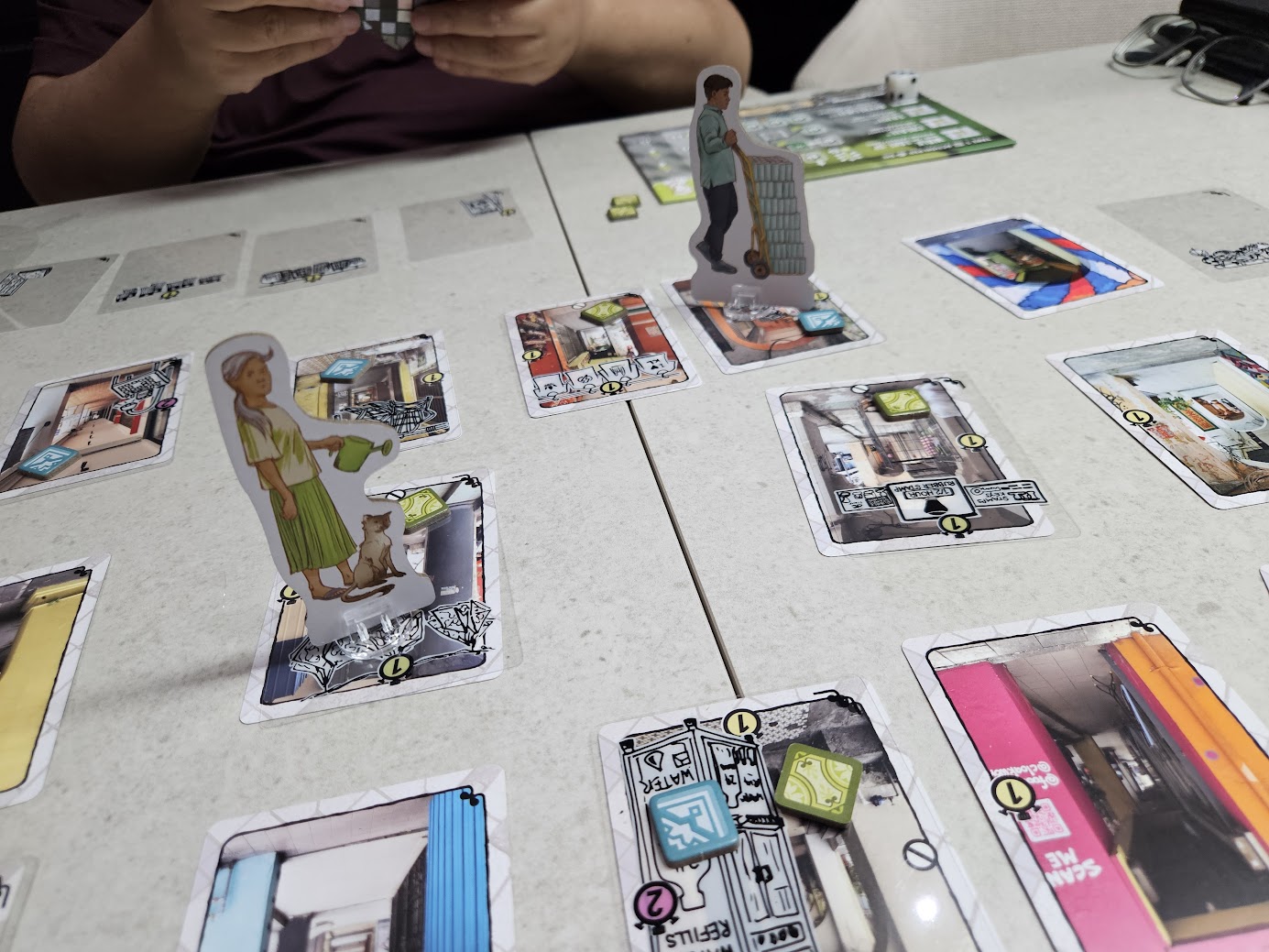 Gameplay photo of the board game Kaki Lima: Downtown KL featuring various components and board state.