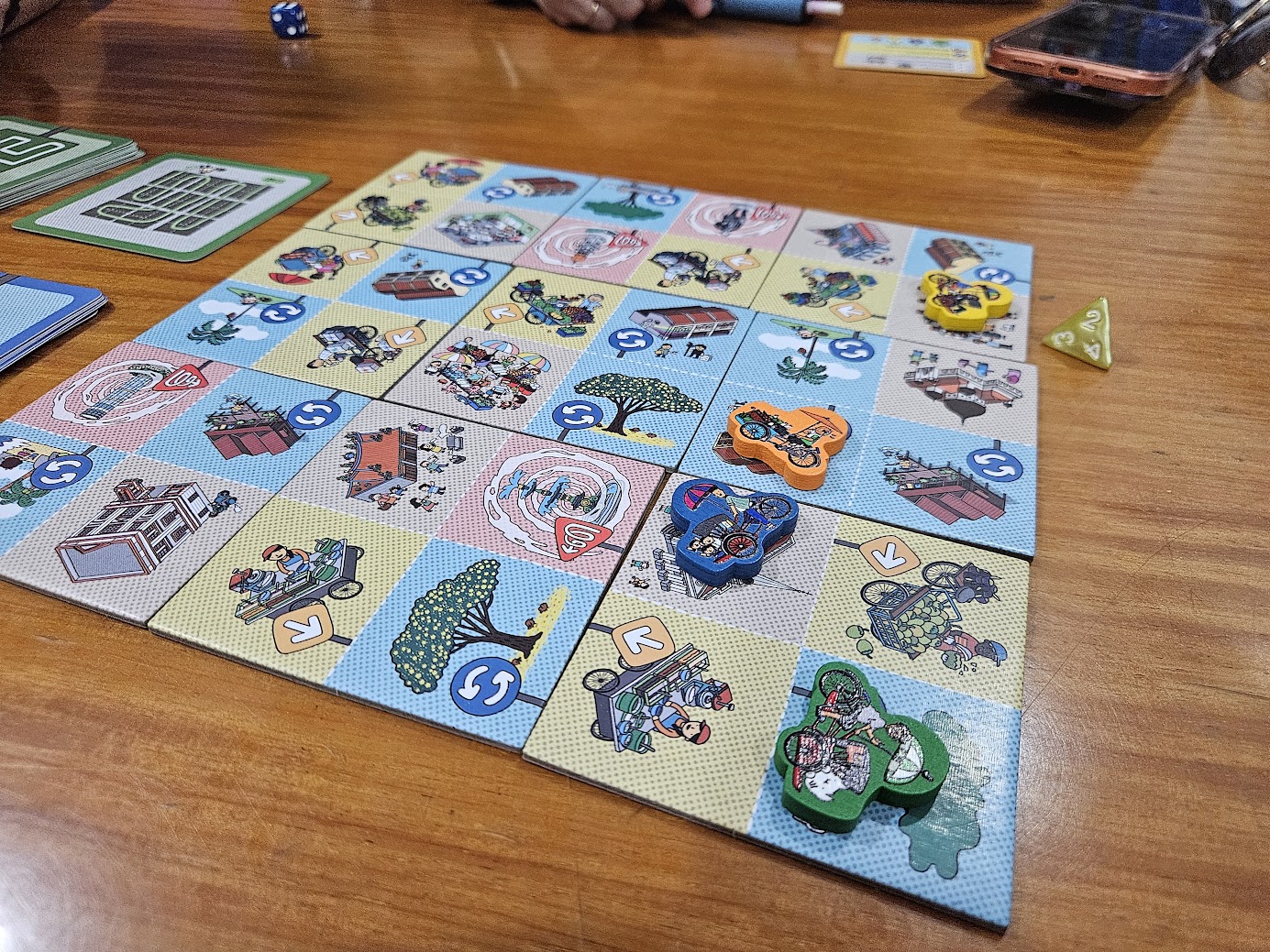 Gameplay photo of the board game Trishaw Frenzy featuring various components and board state.