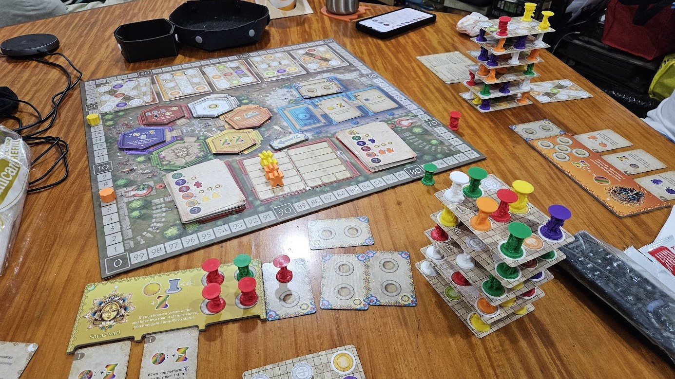 Gameplay photo of the board game Meenakshi Temple featuring various components and board state.