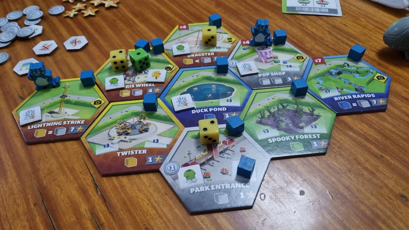 Gameplay photo of the board game Dice Theme Park featuring various components and board state.