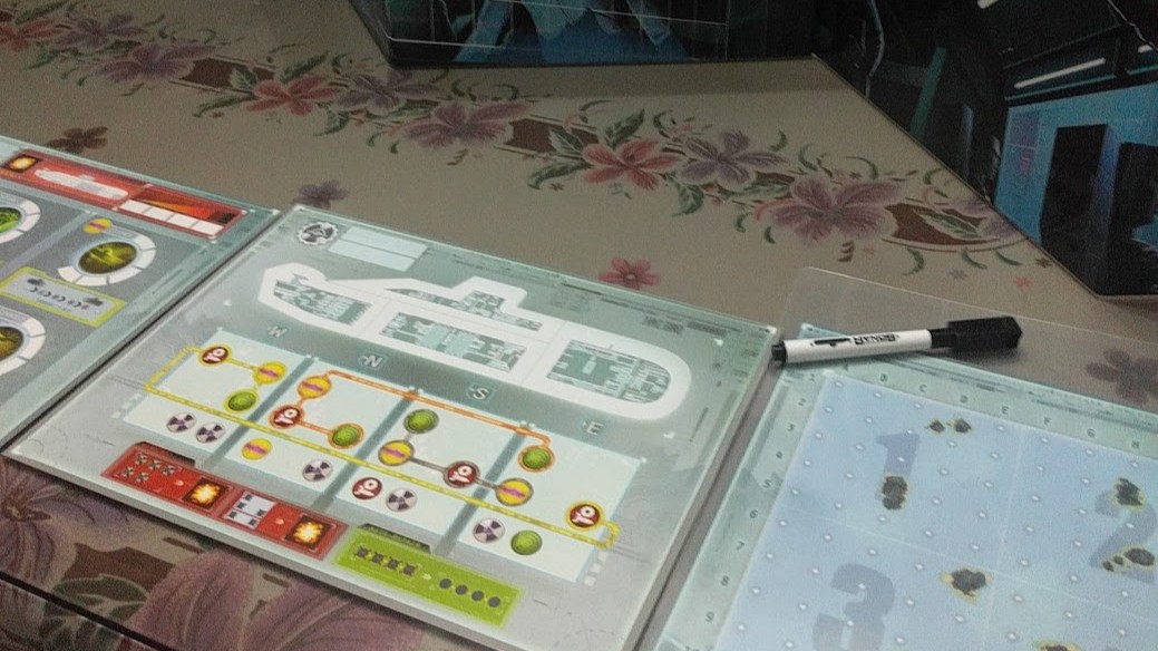 Gameplay photo of the board game Captain Sonar featuring various components and board state.