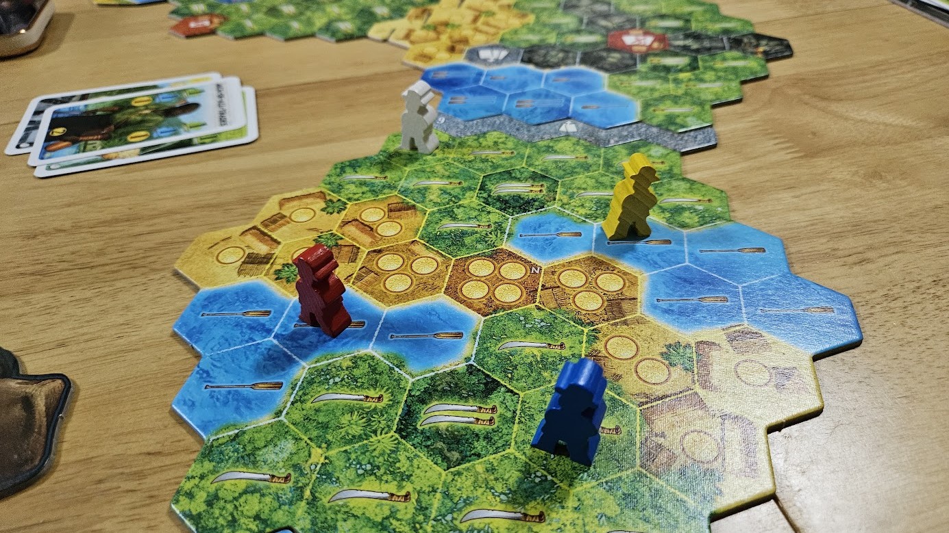 Gameplay photo of the board game The Quest for El Dorado featuring various components and board state.