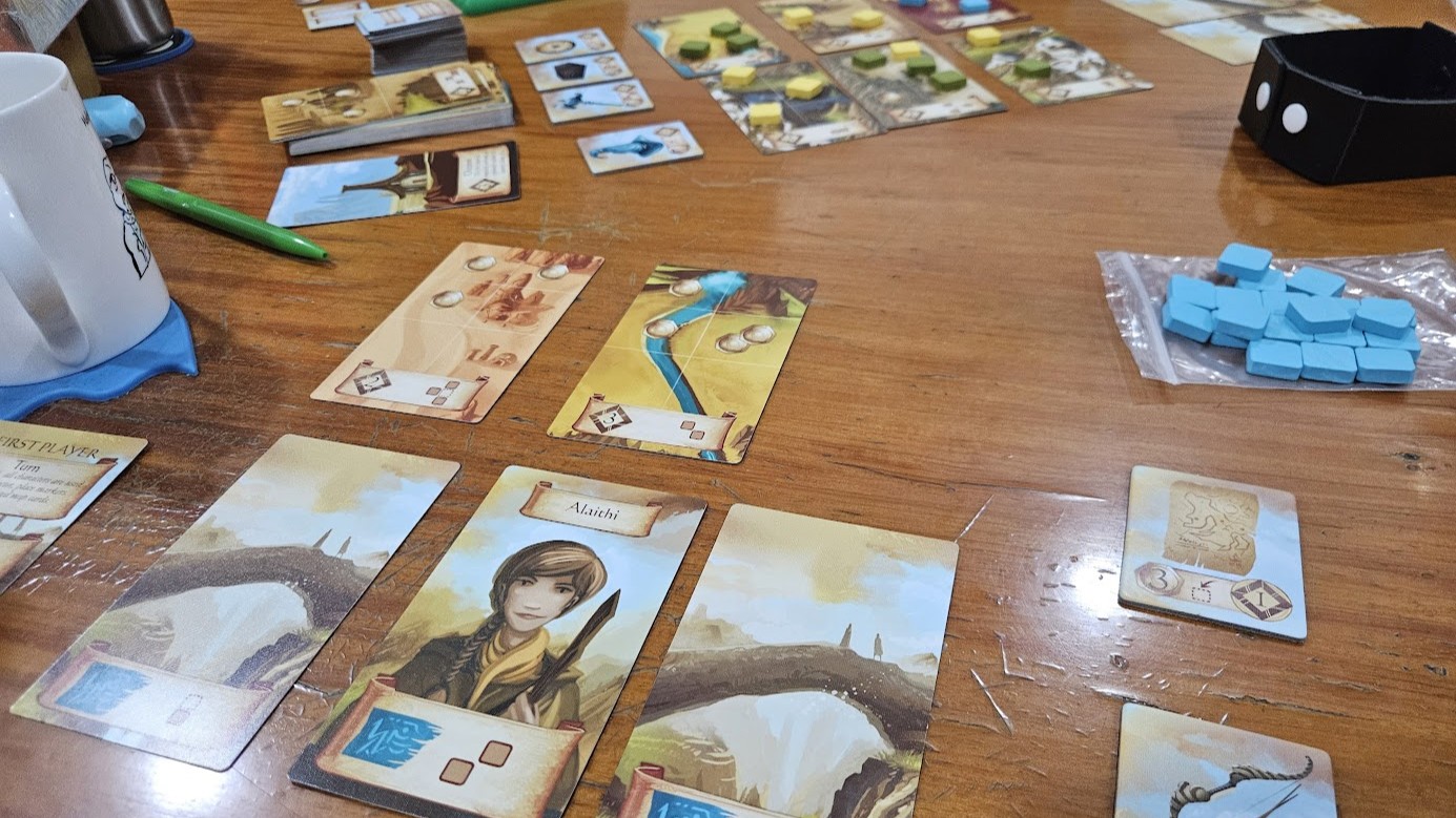 Gameplay photo of the board game Roam featuring various components and board state.