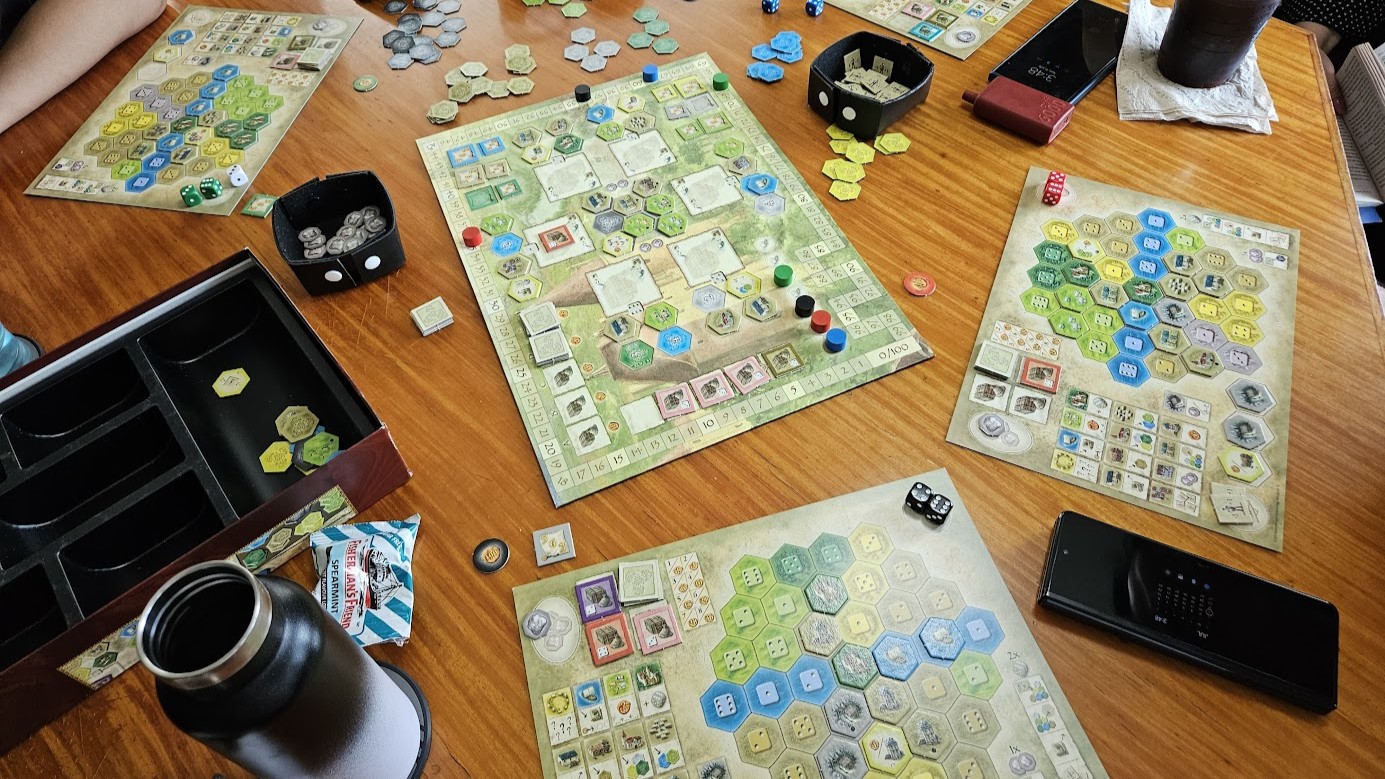 Gameplay photo of the board game The Castles of Burgundy featuring various components and board state.
