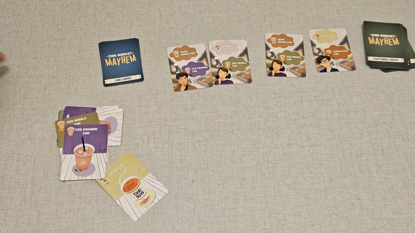 Gameplay photo of the board game Chai Market Mayhem featuring various components and board state.