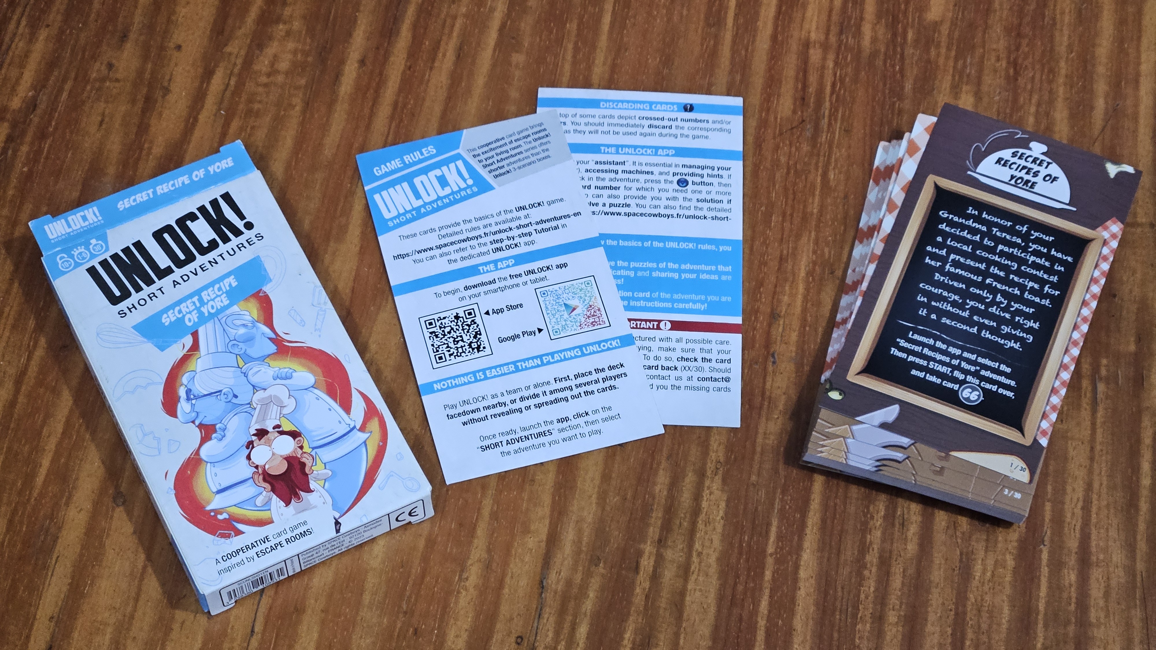 Gameplay photo of the board game Unlock!: Short Adventures – Secret Recipes of Yore featuring various components and board state.