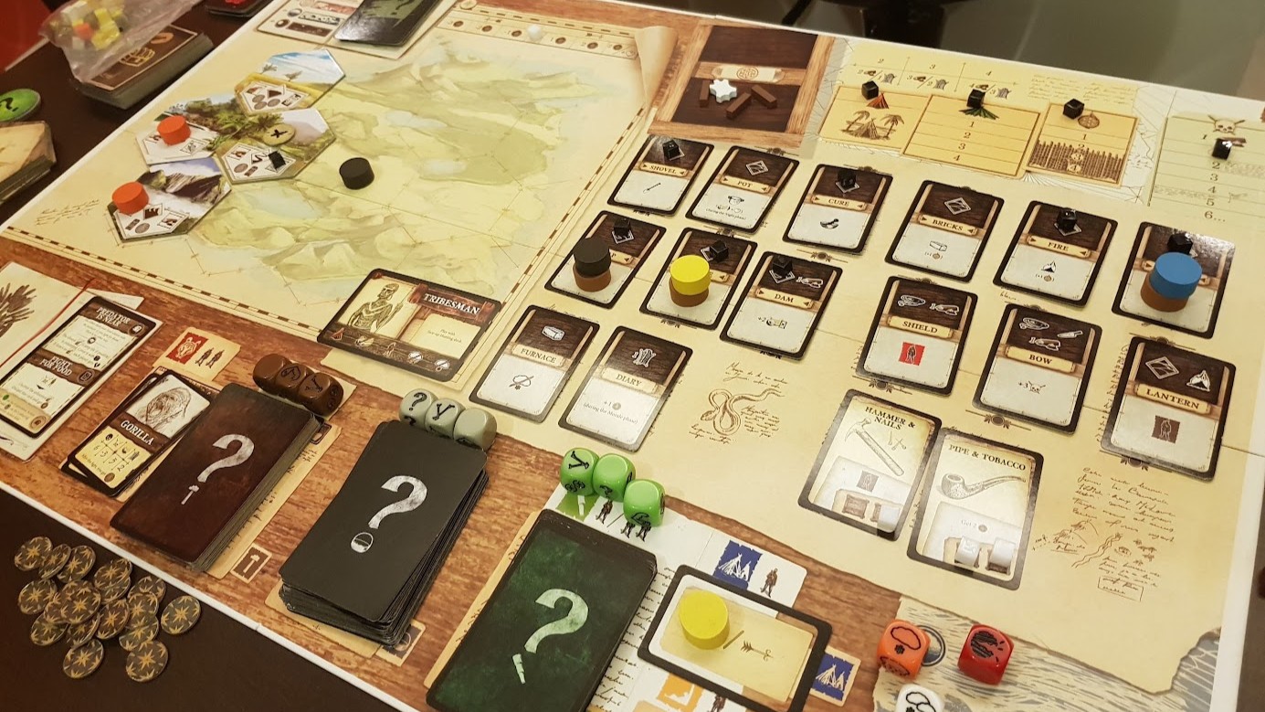Gameplay photo of the board game Robinson Crusoe: Adventure on the Cursed Island featuring various components and board state.