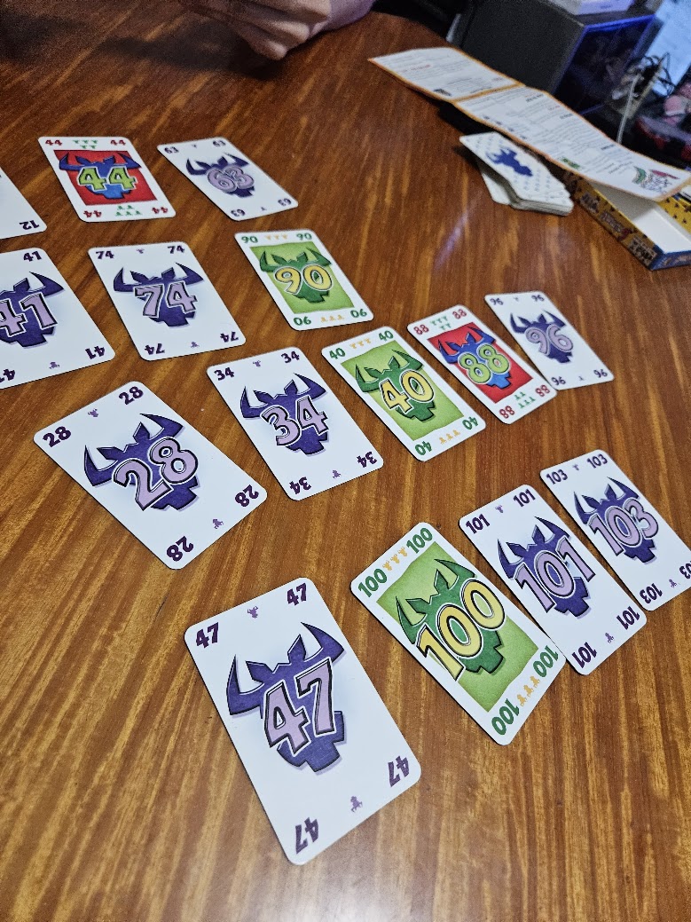 Gameplay photo of the board game 6 nimmt! featuring various components and board state.