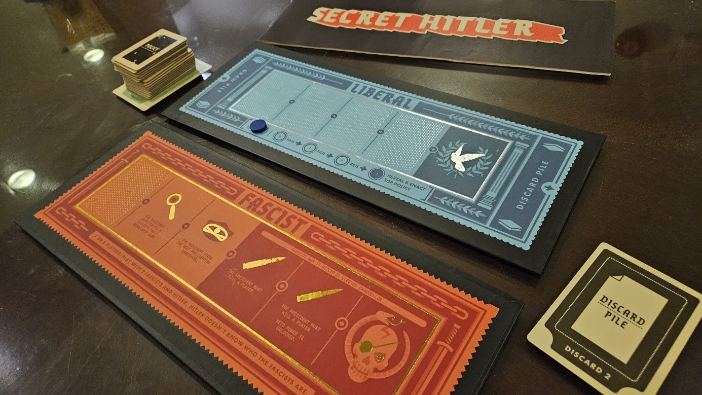 Gameplay photo of the board game Secret Hitler featuring various components and board state.