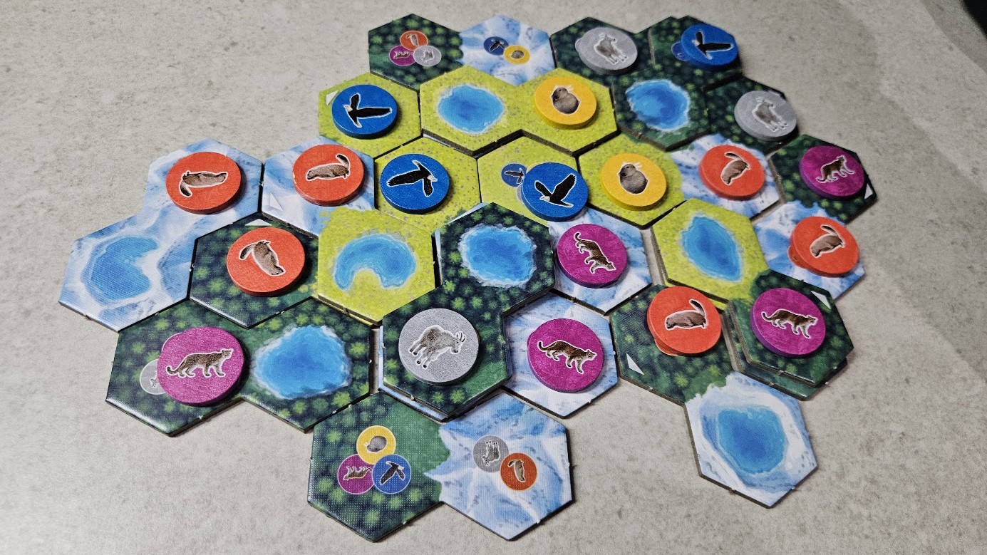 Gameplay photo of the board game Cascadia: Alpine Lakes featuring various components and board state.