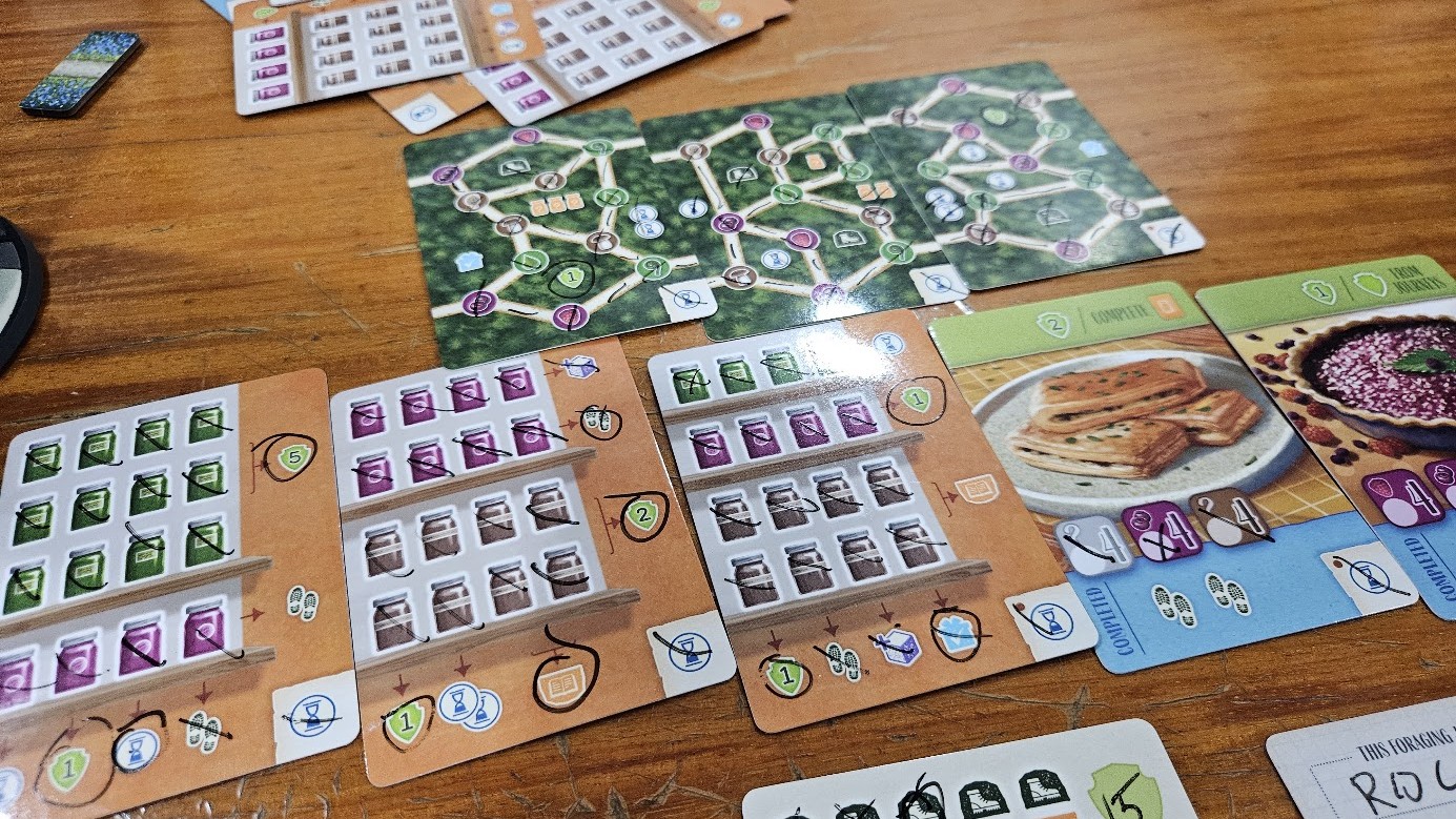 Gameplay photo of the board game Forage featuring various components and board state.