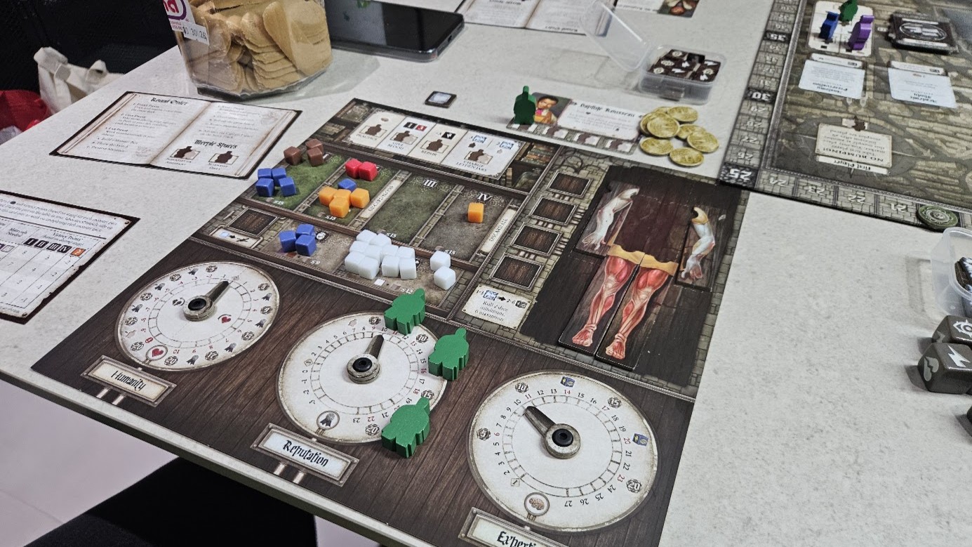 Gameplay photo of the board game Abomination: The Heir of Frankenstein featuring various components and board state.