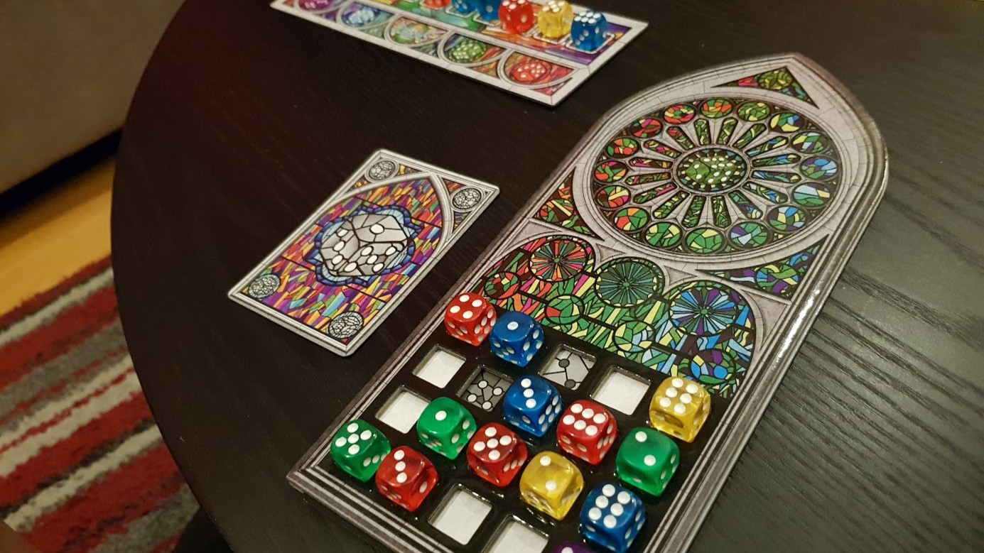 Gameplay photo of the board game Sagrada featuring various components and board state.