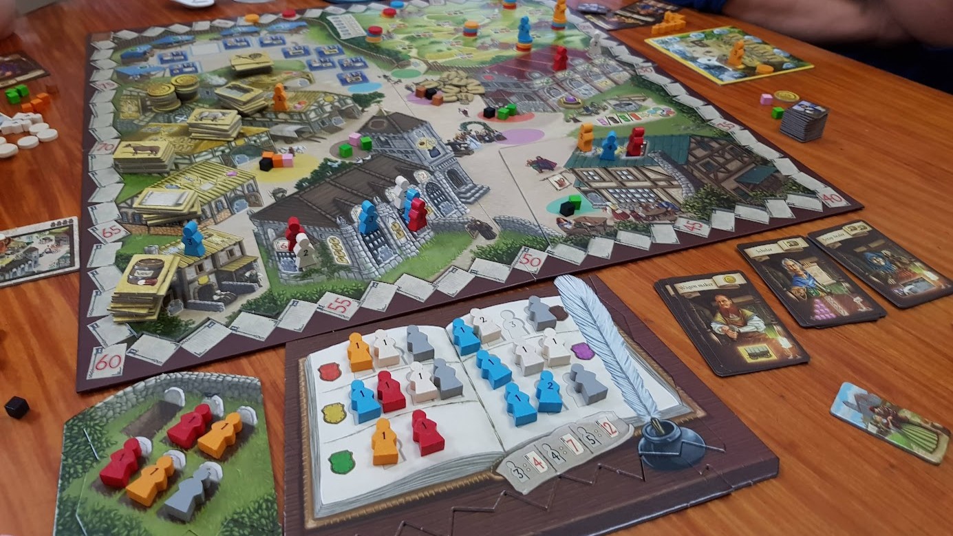 Gameplay photo of the board game Village: Inn featuring various components and board state.