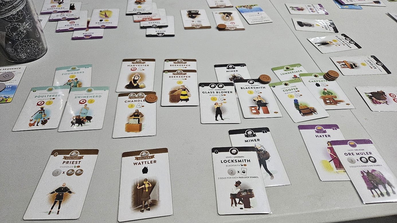 Gameplay photo of the board game Villagers featuring various components and board state.