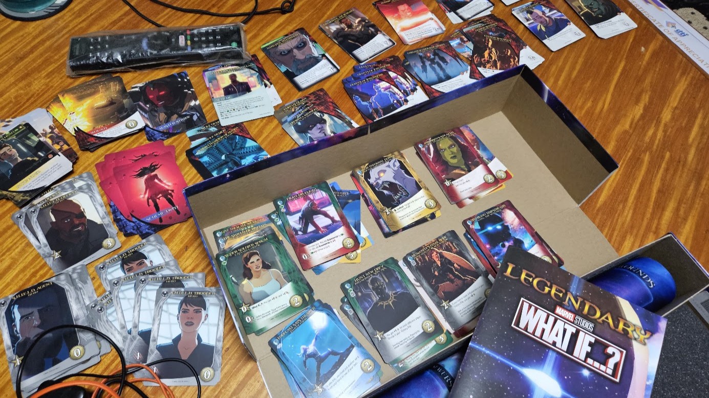 Gameplay photo of the board game Legendary: A Marvel Deck Building Game – Marvel Studios' What If...? featuring various components and board state.