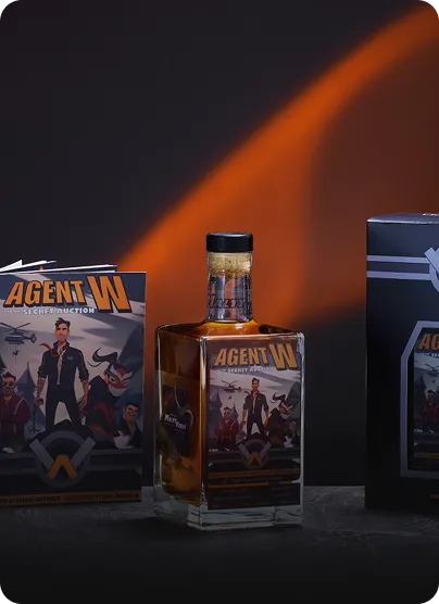 Bottle of Agent W Secret Auction whiskey with packaging featuring illustrated characters on a dark background.
