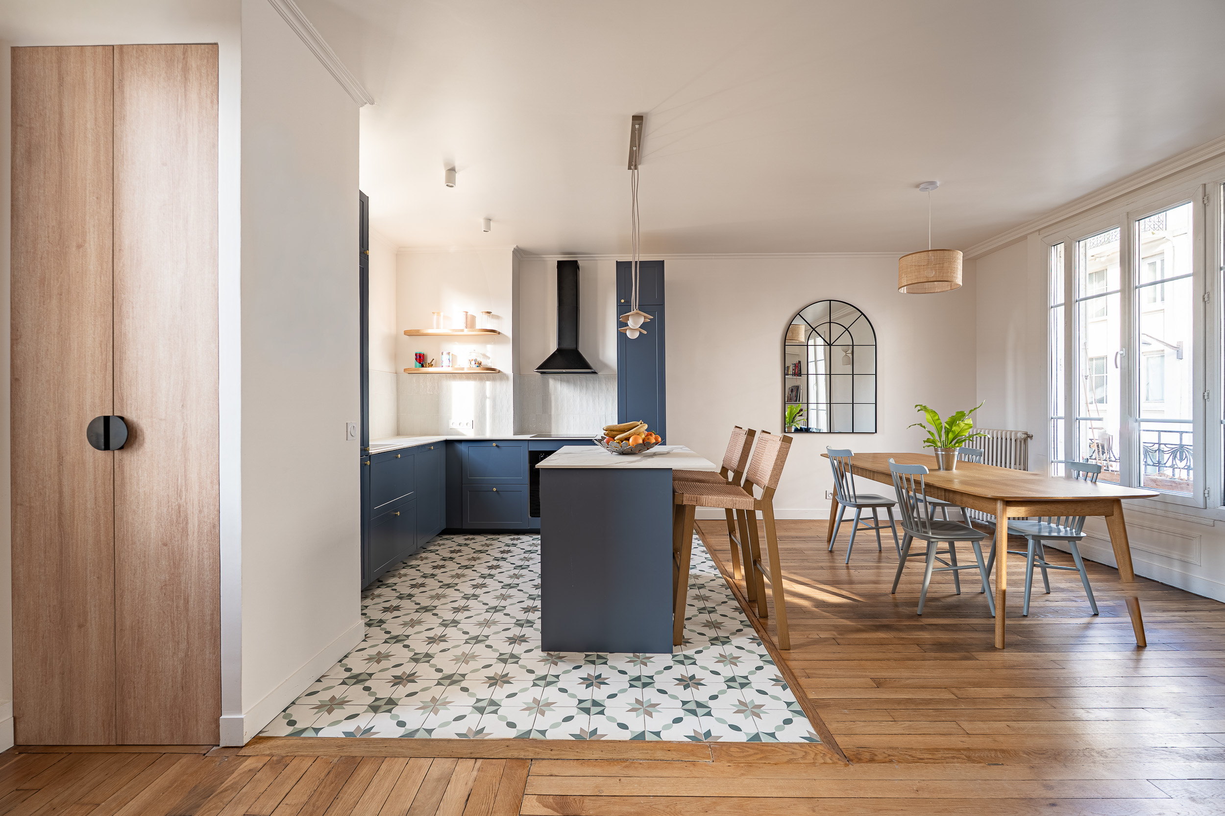 Salle à manger rénovée par Père Castor avec parquet et luminaires design dans un appartement parisien