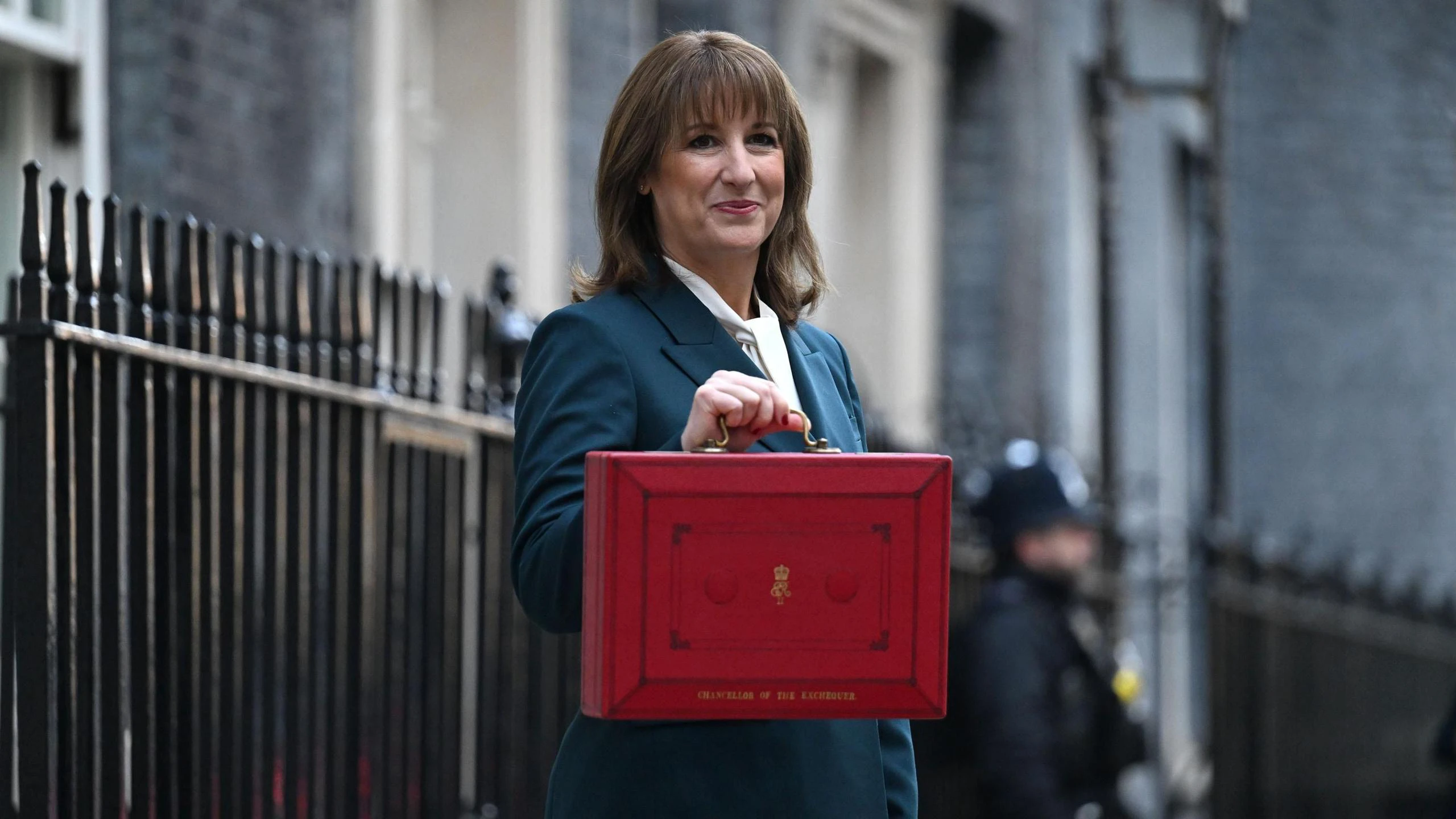 A government minister holding a red Budget box outside 11 Downing Street