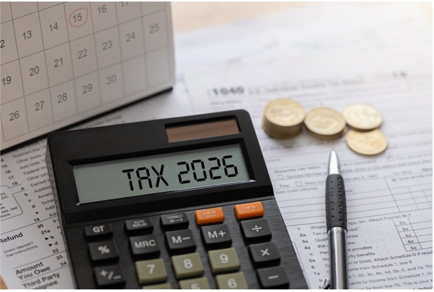 Calculator displaying tax 2026 with documents, coins and calendar illustrating tax deadlines and compliance