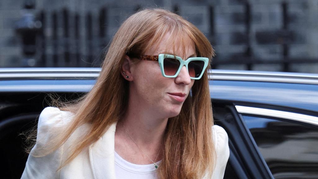 Press photograph of a female UK politician arriving from a car wearing sunglasses, commonly used to represent government policy, political scrutiny, housing reform, taxation or public commentary relating to SDLT and property legislation.