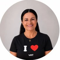 Portrait of a smiling woman wearing a black t-shirt with an "I heart VAT" design.