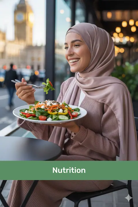 Smiling woman wearing a hijab eating a fresh vegetable salad at a cafe with an urban background.
